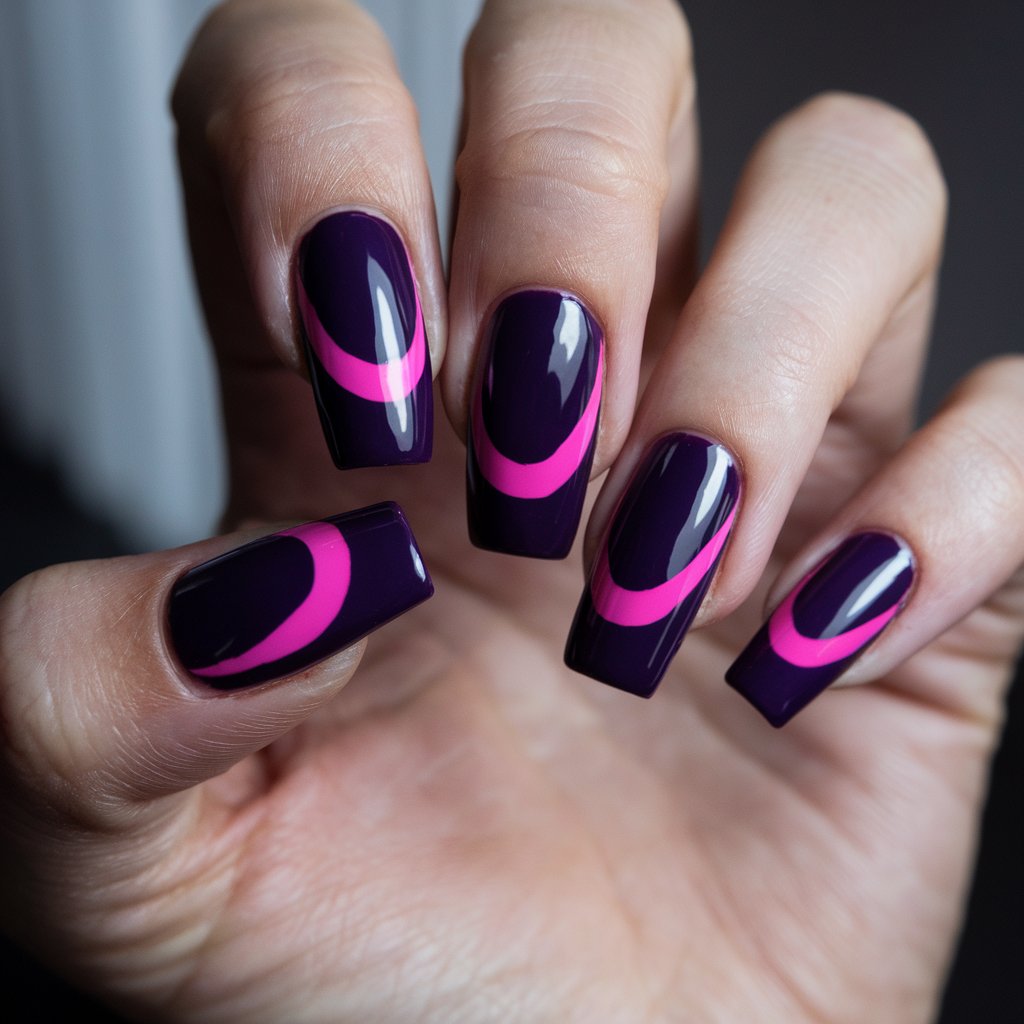 A photo of a well-moisturized woman's hand with five fingers featuring a dramatic deep purple base and striking neon pink accents. The high-gloss finish reflects the natural background lighting, intensifying the bold contrast between the colors. The long coffin-shaped nails create an edgy, high-fashion look.