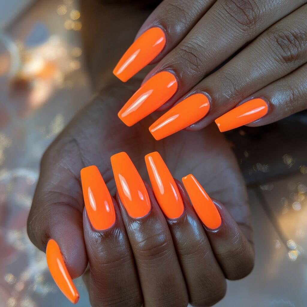 A close-up shot of a woman's hand with neon orange nails. The nails are long and coffin-shaped, with a high-gloss finish. The nails radiate an intense glow. The woman's fingers are gently fanned out, showcasing the seamless polish application and impeccable cuticle care. The background is softly blurred, with hints of sunlight filtering through.