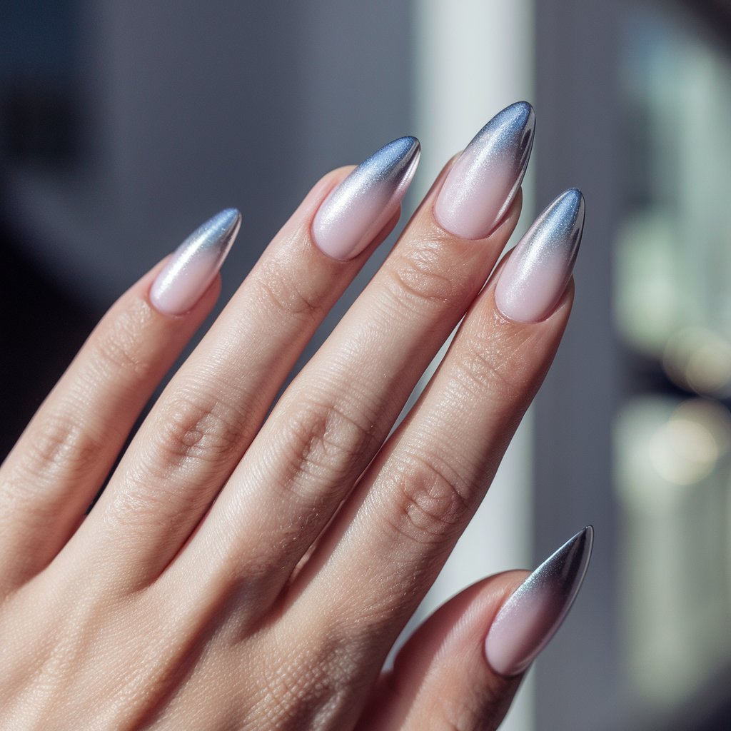 A photo of a woman's hand with well-moisturized oily skin. She has five fingers and is wearing stiletto nails that transition from a soft pink base to frosted silver chrome tips. The nails have a modern baby boomer effect. The background is blurry and contains a window with bright sunlight. The chrome nails shimmer subtly, blending warm and cool tones seamlessly. The glossy, hydrated skin enhances the gentle gradient, giving this French fade a futuristic, luminous update.